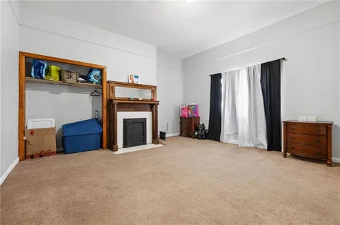 a view of a livingroom with a fireplace and a window
