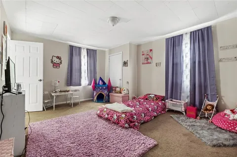 a bed room with a bed and a chair