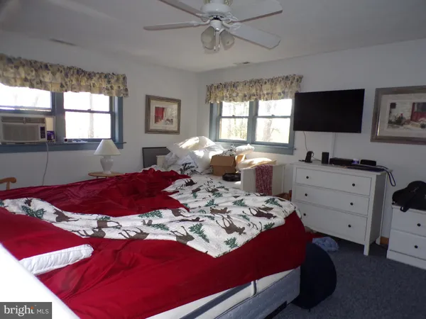 a bathroom with a granite countertop toilet sink and mirror