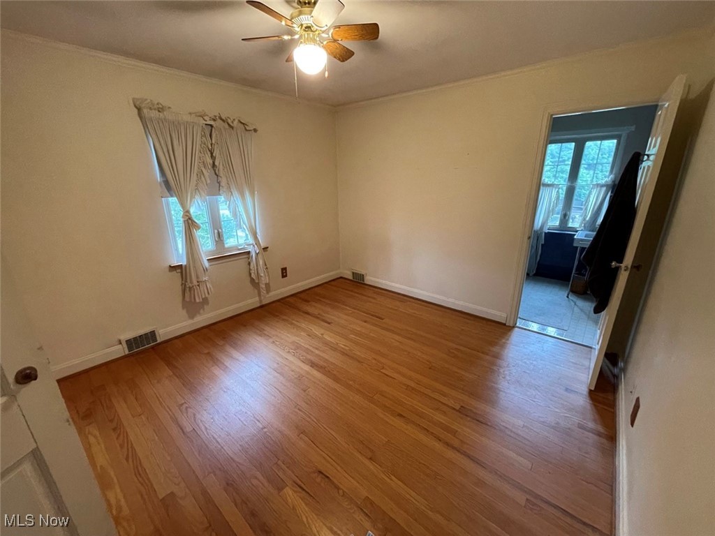 2702 Martin Road Zanesville, OH 43701 - Photo 23 of 34 Bedroom featuring light wood-type flooring, crown molding, and ceiling fan