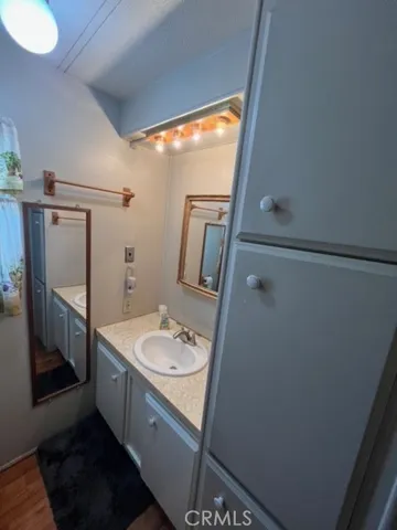 a bathroom with a sink a mirror and shower