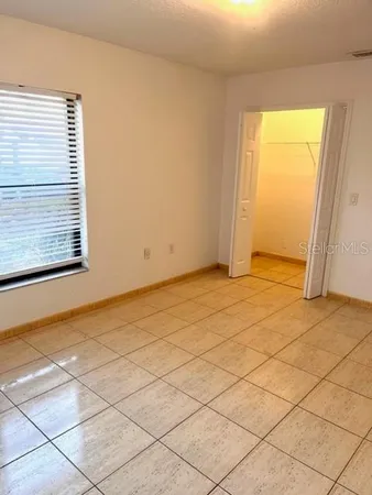 a view of an empty room and a window