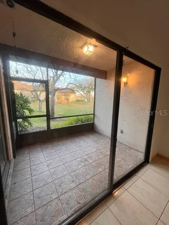 a view of a room with wooden floor and windows