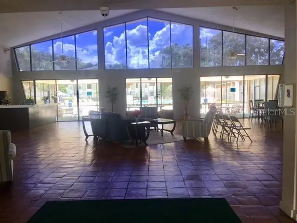 a lobby with furniture and floor to ceiling windows
