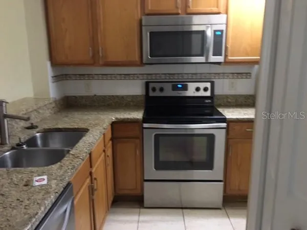 a kitchen with a stove microwave and sink