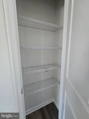 a view of walk in closet with empty racks