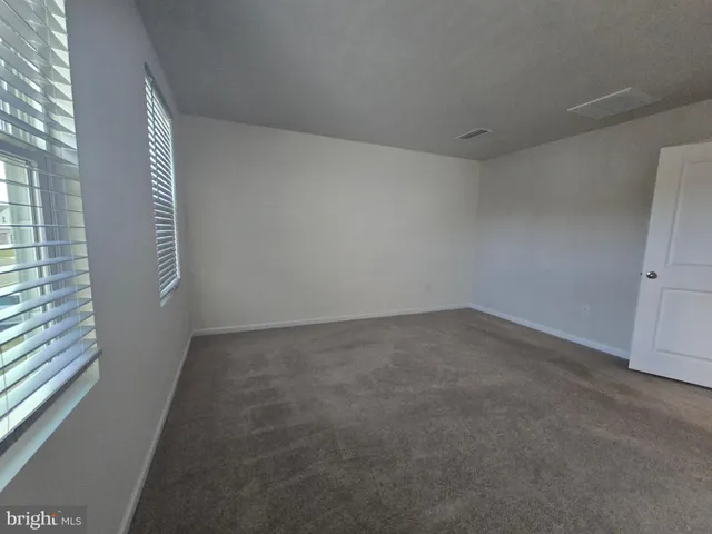 a view of an empty room and a window