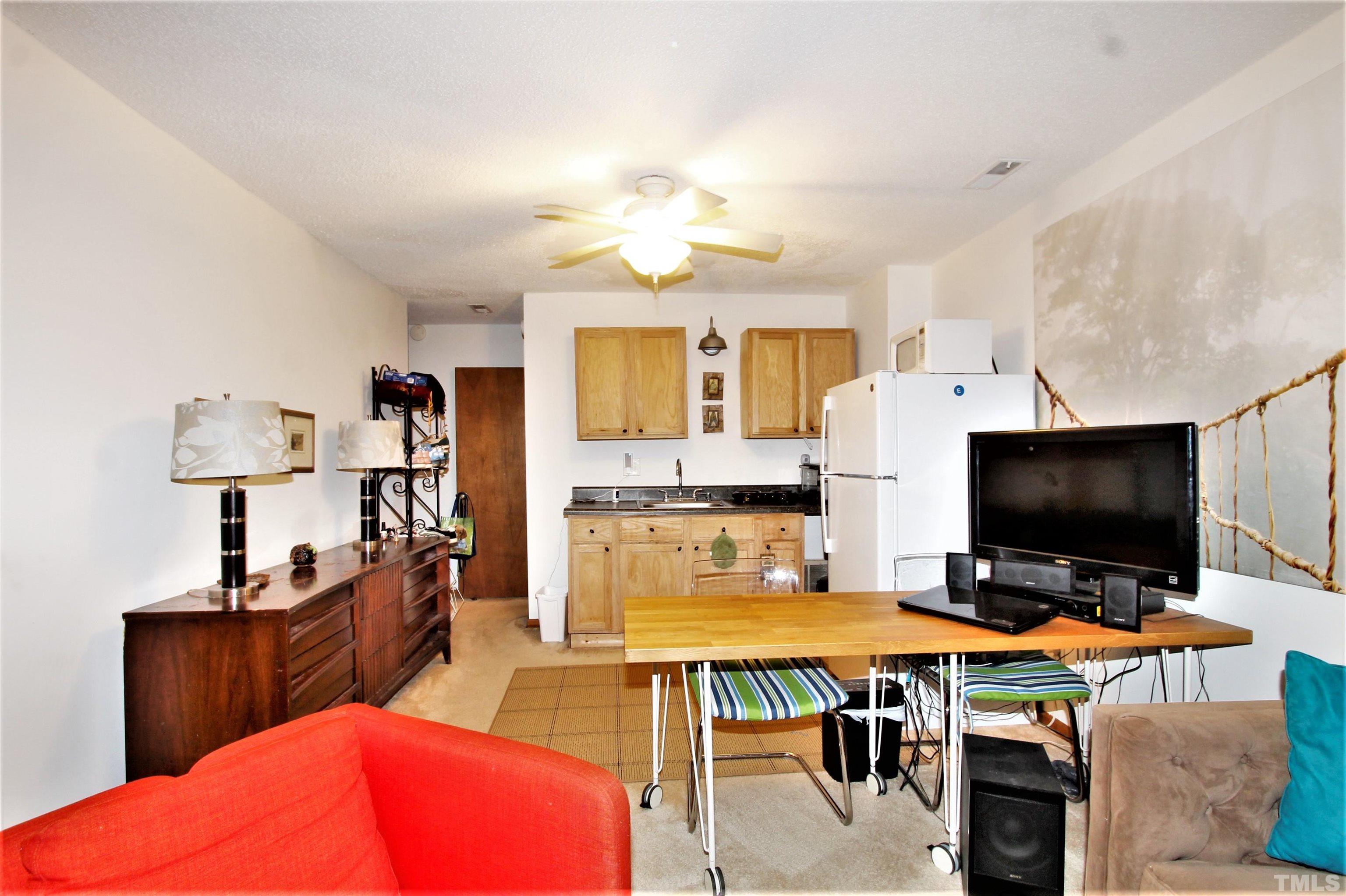 17 Prestwick Place, Unit 17 Durham, NC 27705 - Photo 22 of 27 a living room with furniture and a flat screen tv