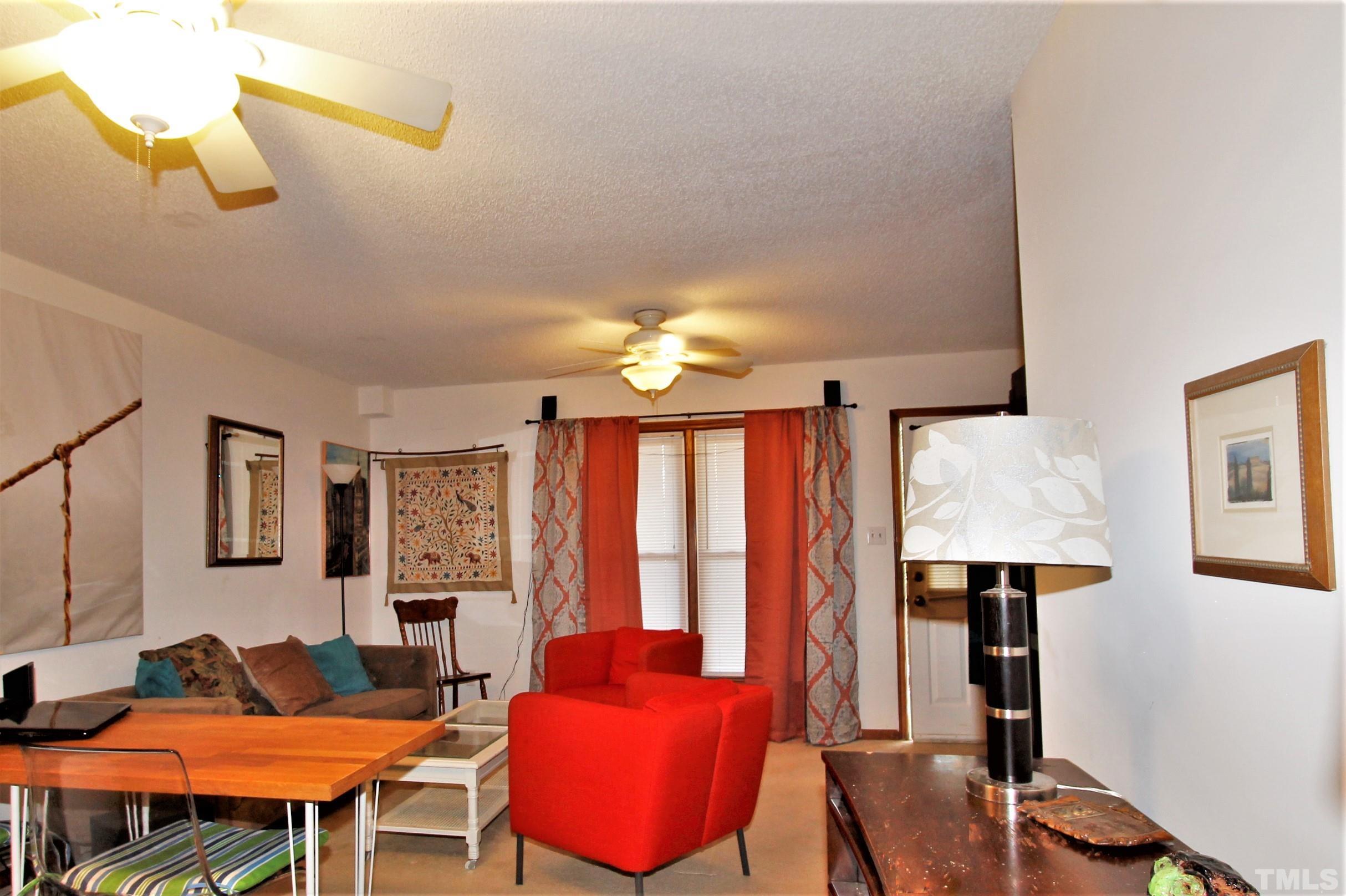 17 Prestwick Place, Unit 17 Durham, NC 27705 - Photo 23 of 27 a living room with furniture and a lamp