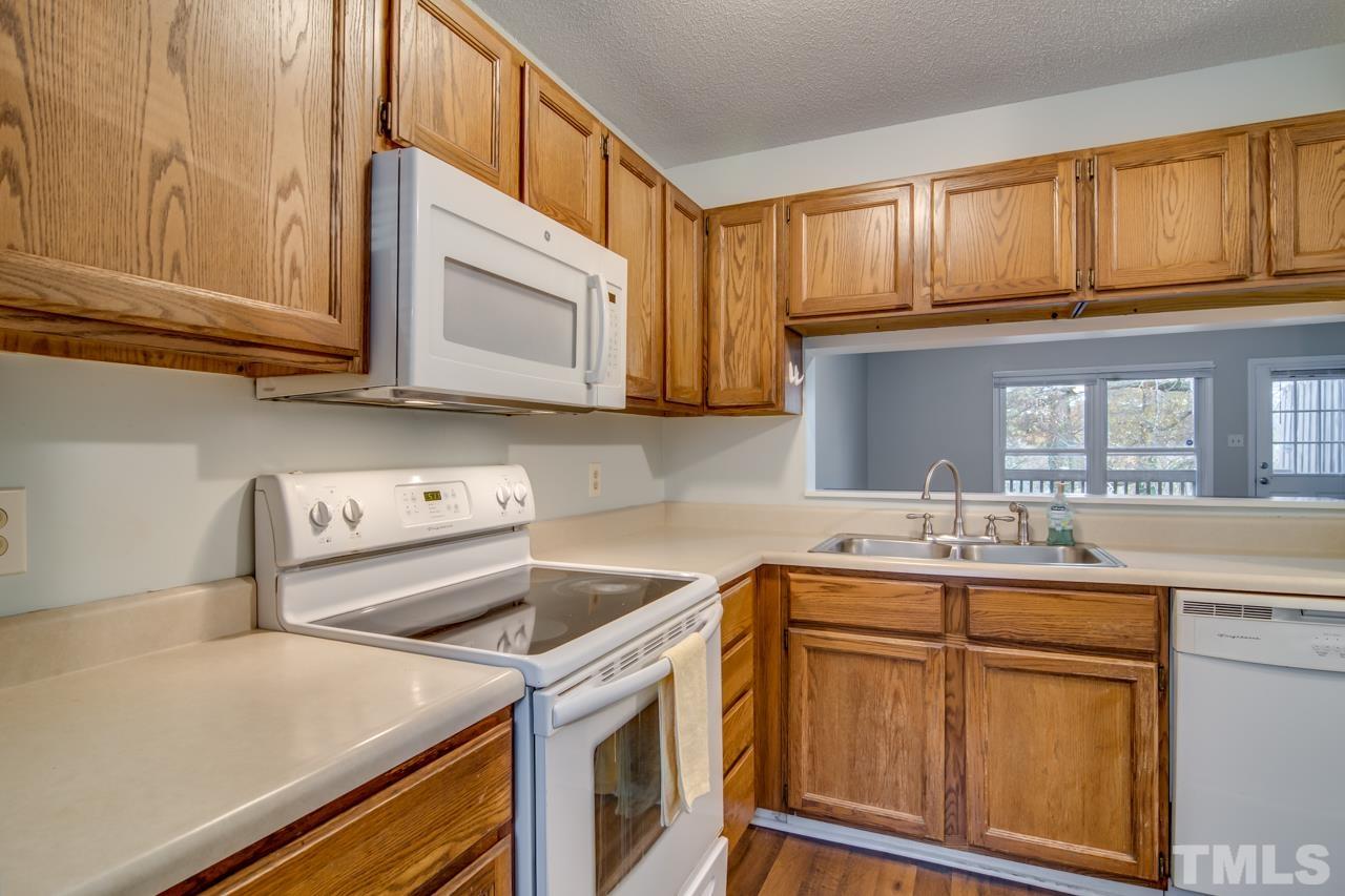 17 Prestwick Place, Unit 17 Durham, NC 27705 - Photo 6 of 27 a kitchen with stainless steel appliances granite countertop a sink stove and cabinets