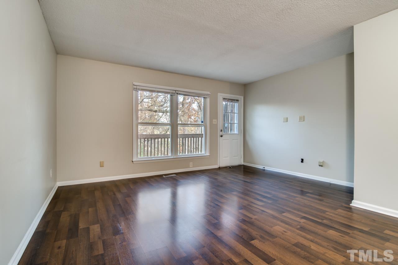 17 Prestwick Place, Unit 17 Durham, NC 27705 - Photo 7 of 27 an empty room with wooden floor and windows