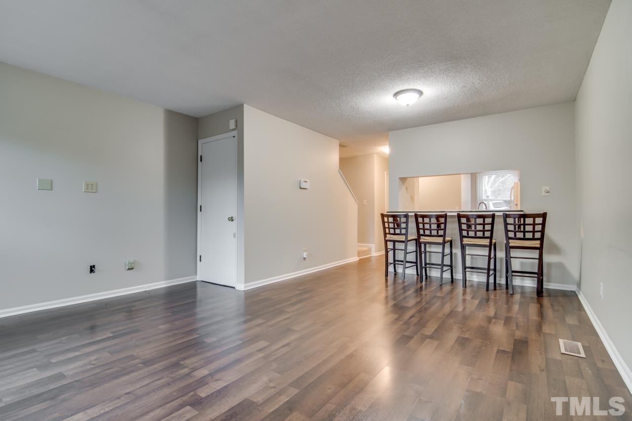 17 Prestwick Place, Unit 17 Durham, NC 27705 - Photo 9 of 27 a view of an empty room with wooden floor and a window