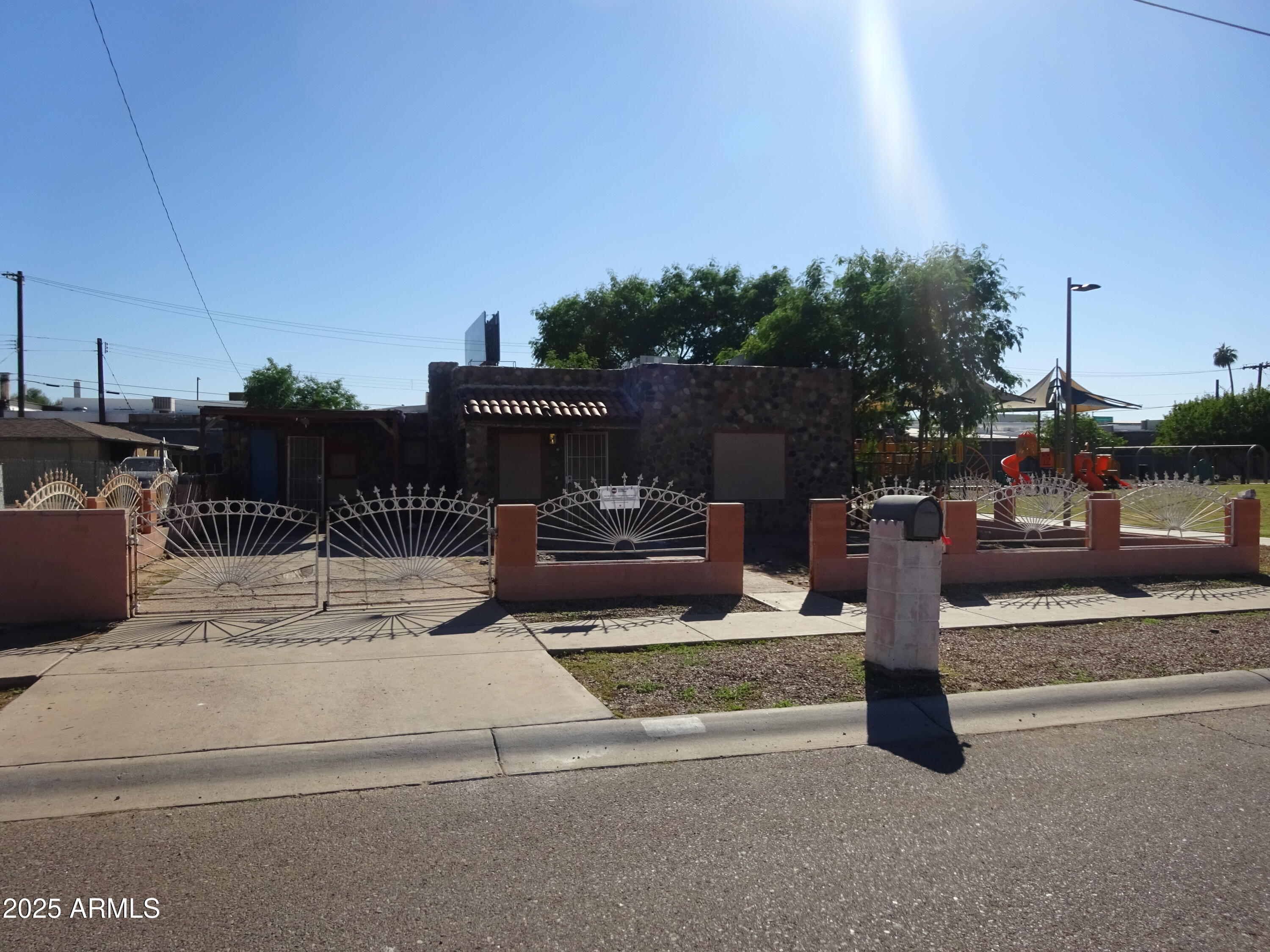 2821 East Adams Street Phoenix, AZ 85034 - Photo 2 of 17 a view of a patio with table and chairs potted plants with wooden fence