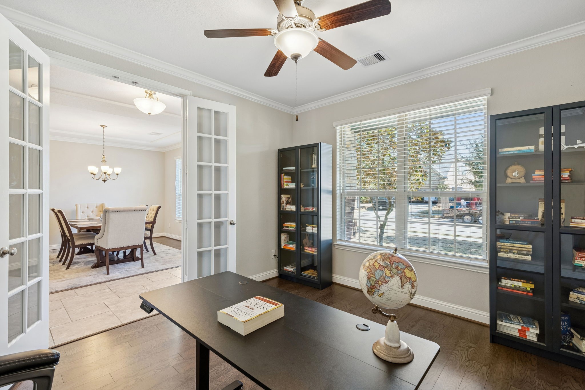 1619 Dove Ridge Drive Katy, TX 77493 - Photo 13 of 28 Work from home in style within this private study secured by elegant double French doors. The room features warm engineered wood floors and a wall of windows.