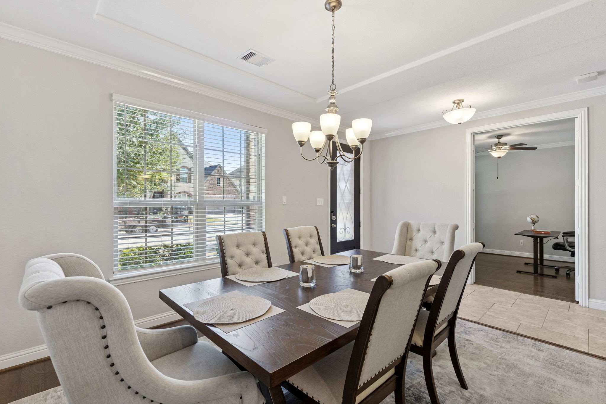 1619 Dove Ridge Drive Katy, TX 77493 - Photo 3 of 28 Host unforgettable dinners in this light-filled formal dining room featuring elegant crown molding, a statement chandelier, and oversized front-facing windows that flood the space with natural light. The open flow to the adjoining flex room makes it perfect for entertaining, a home office, or an additional sitting area to fit your lifestyle.