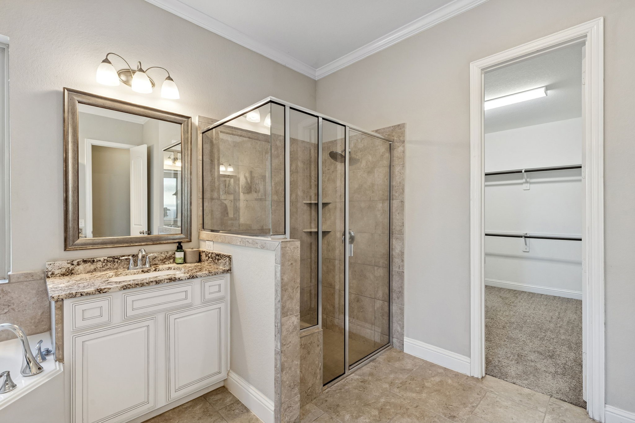 1619 Dove Ridge Drive Katy, TX 77493 - Photo 10 of 28 Experience modern luxury in the primary bathroom, which offers a spacious walk-in shower with designer tile and a frameless glass enclosure. The layout provides a seamless transition to the primary closet.
