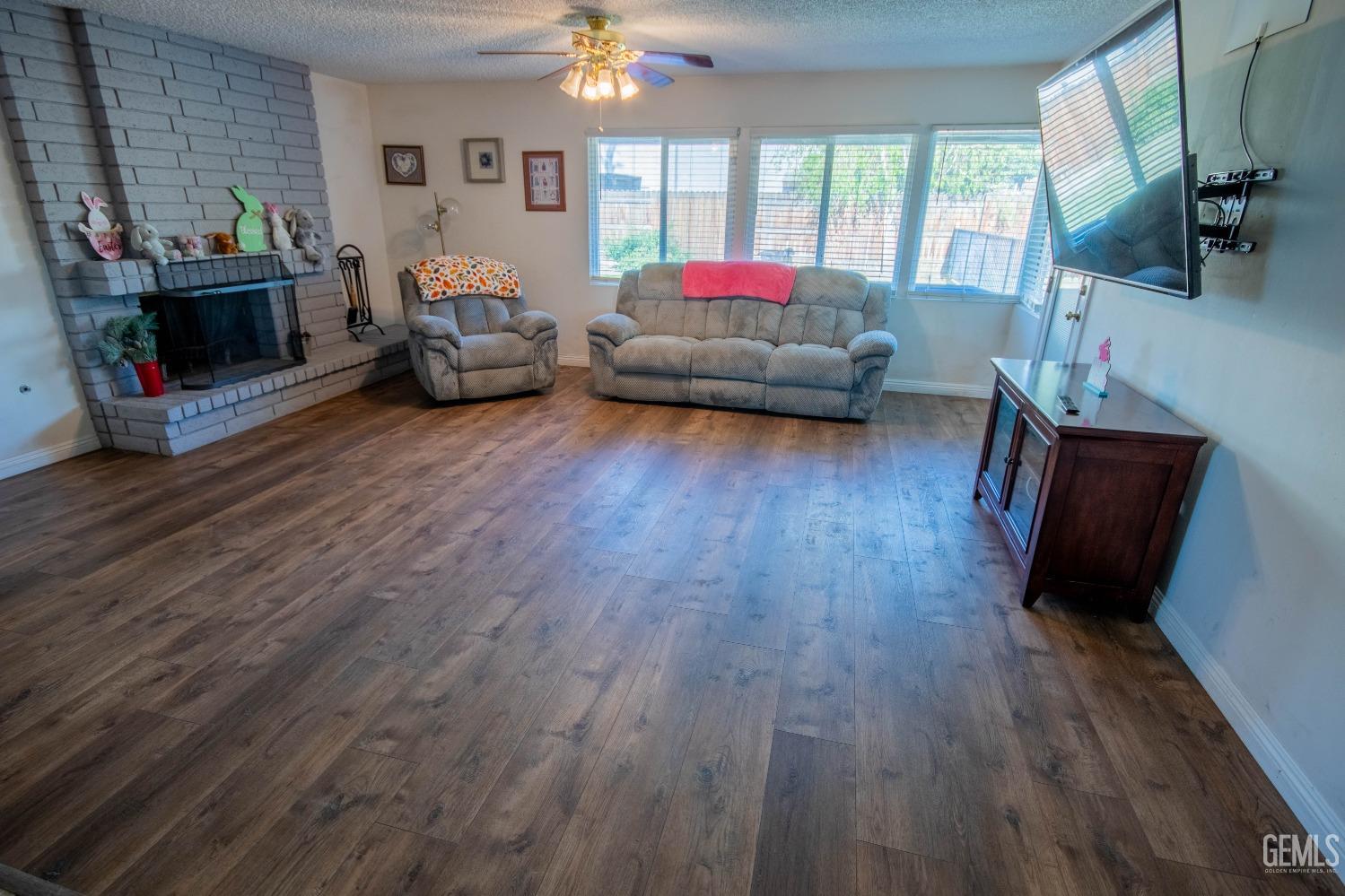 Undisclosed Address Bakersfield, CA 93309 - Photo 11 of 46 a living room with furniture and a fireplace