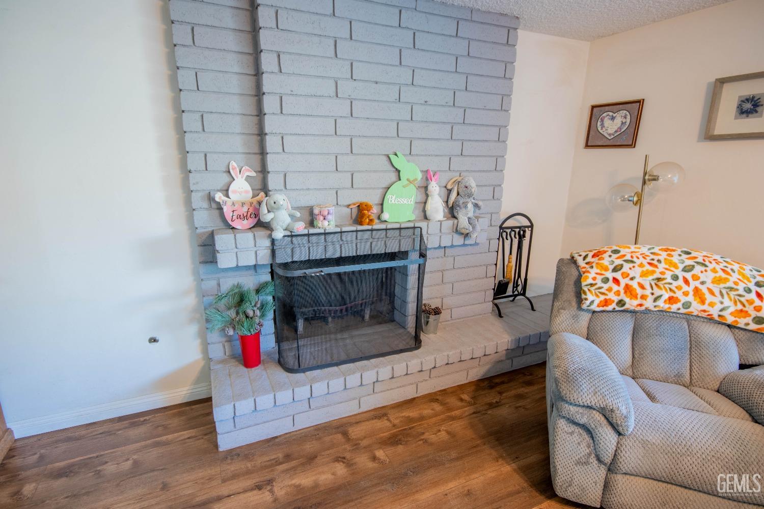 Undisclosed Address Bakersfield, CA 93309 - Photo 12 of 46 a living room with furniture and a fireplace