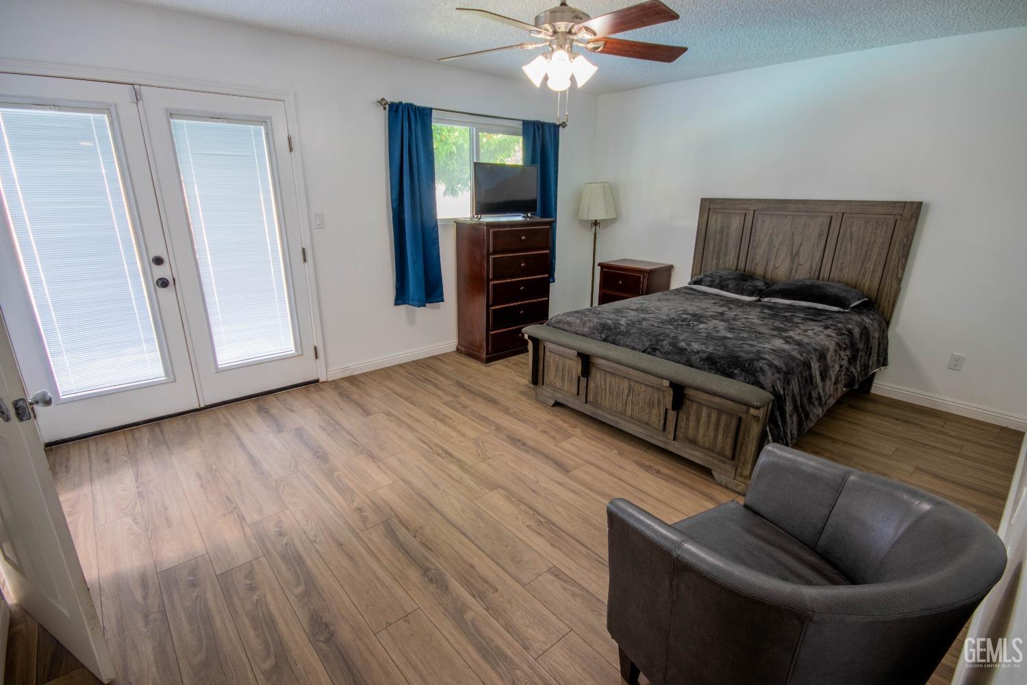 Undisclosed Address Bakersfield, CA 93309 - Photo 20 of 46 a living room with furniture and a wooden floor