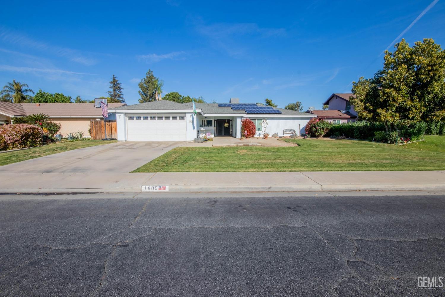 Undisclosed Address Bakersfield, CA 93309 - Photo 2 of 46 front view of a house next to a yard