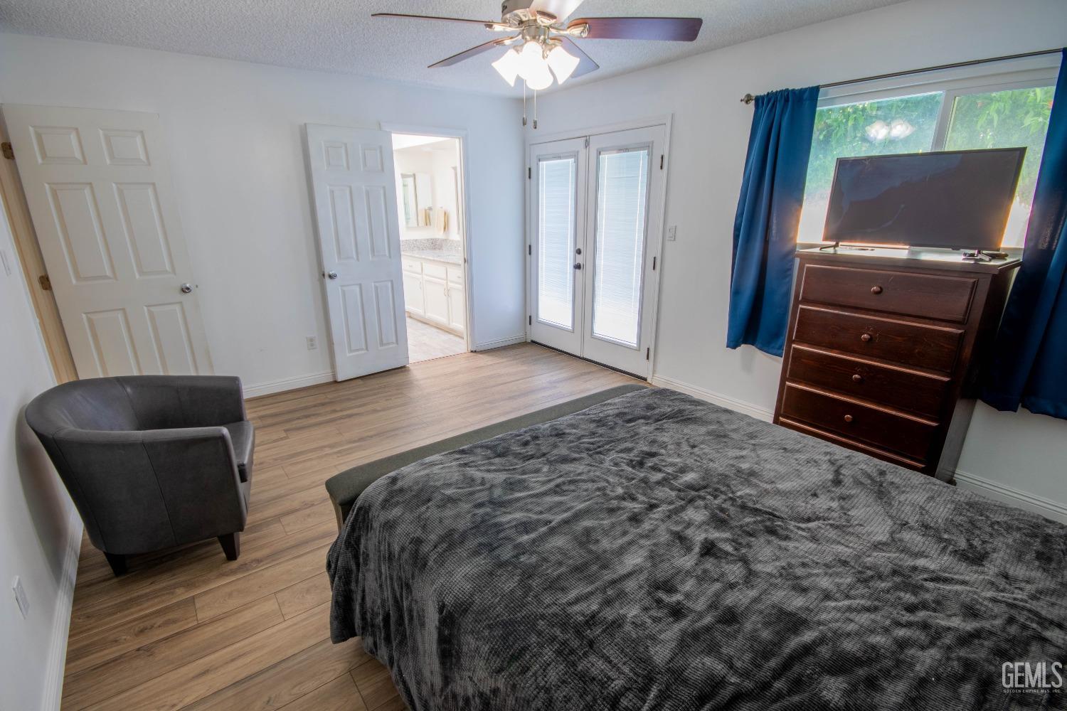 Undisclosed Address Bakersfield, CA 93309 - Photo 21 of 46 a spacious bedroom with a bed and a television
