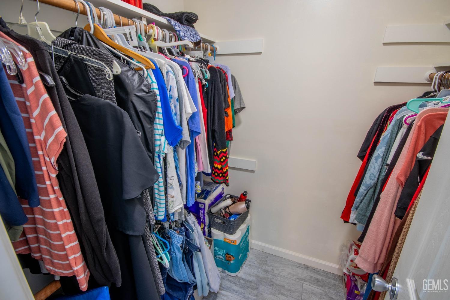 Undisclosed Address Bakersfield, CA 93309 - Photo 24 of 46 a view of walk in closet with clothes