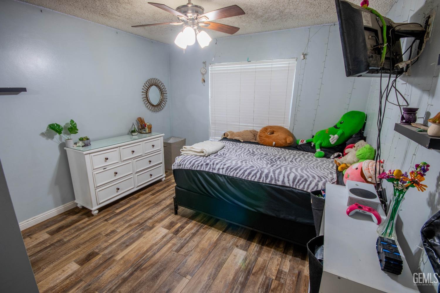 Undisclosed Address Bakersfield, CA 93309 - Photo 25 of 46 a bedroom with a bed and a chandelier