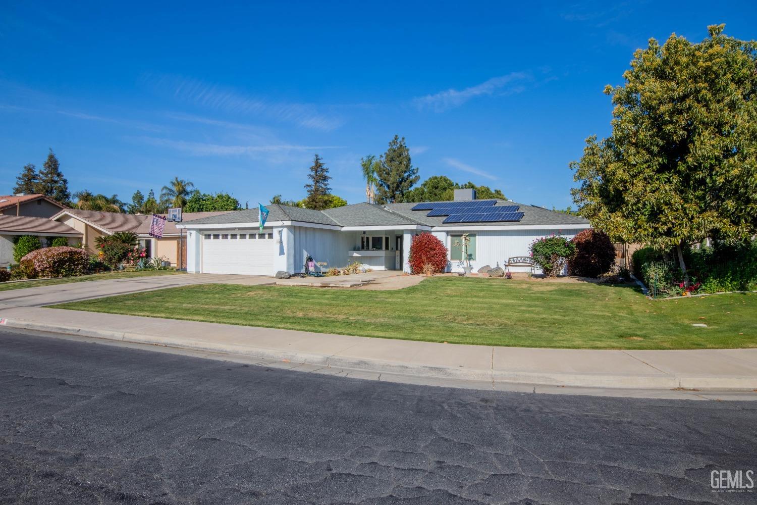 Undisclosed Address Bakersfield, CA 93309 - Photo 3 of 46 a view of a house with a big yard and large trees