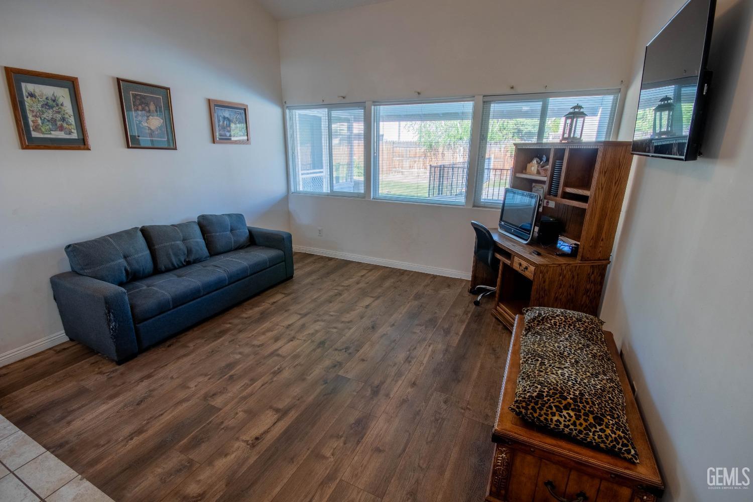 Undisclosed Address Bakersfield, CA 93309 - Photo 8 of 46 a living room with furniture a flat screen tv and a window
