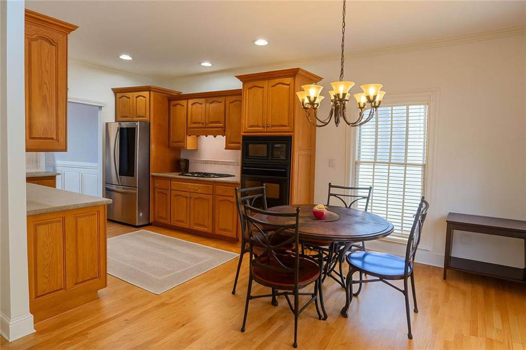 2014 Hubbard Court Villa Rica, GA 30180 - Photo 18 of 41 a kitchen with stainless steel appliances granite countertop a kitchen island a table and chairs in it