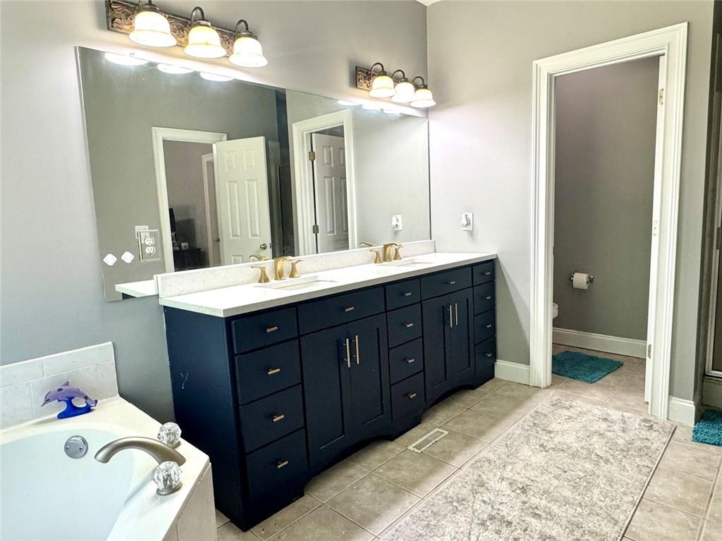 2014 Hubbard Court Villa Rica, GA 30180 - Photo 26 of 41 a spacious bathroom with a double vanity sink and a mirror