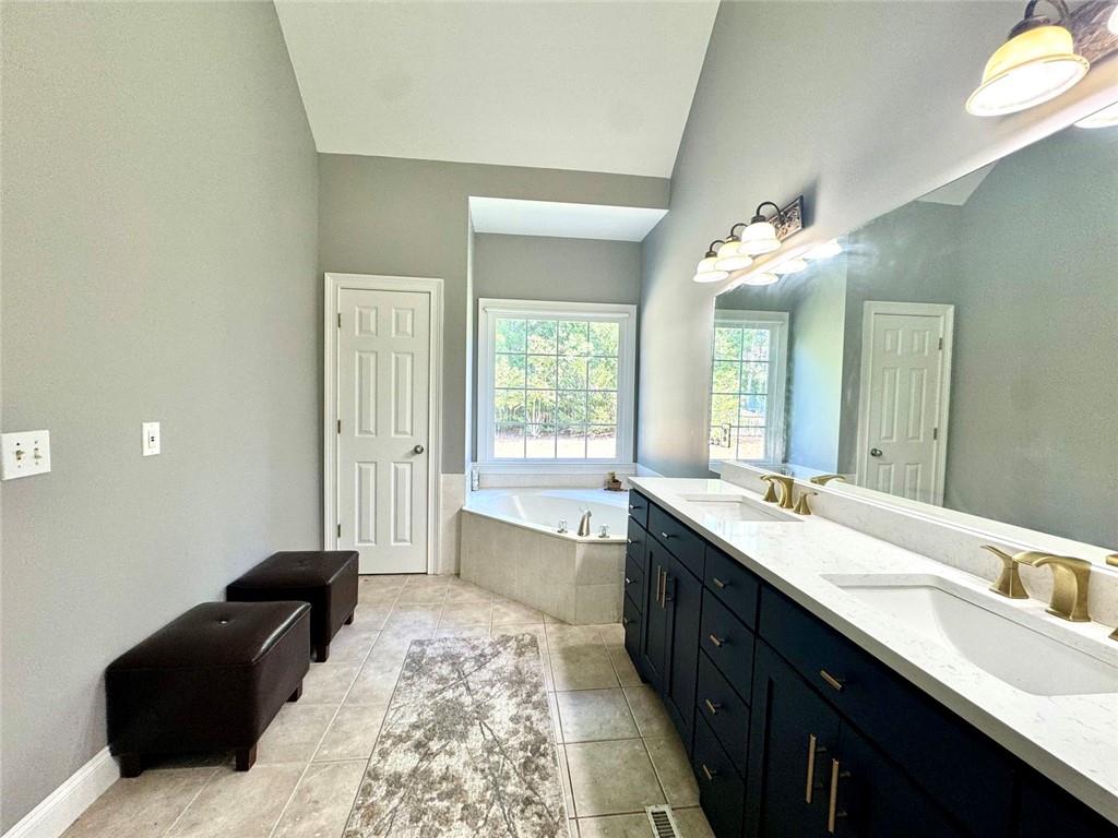 2014 Hubbard Court Villa Rica, GA 30180 - Photo 27 of 41 a spacious bathroom with a double vanity sink and a mirror