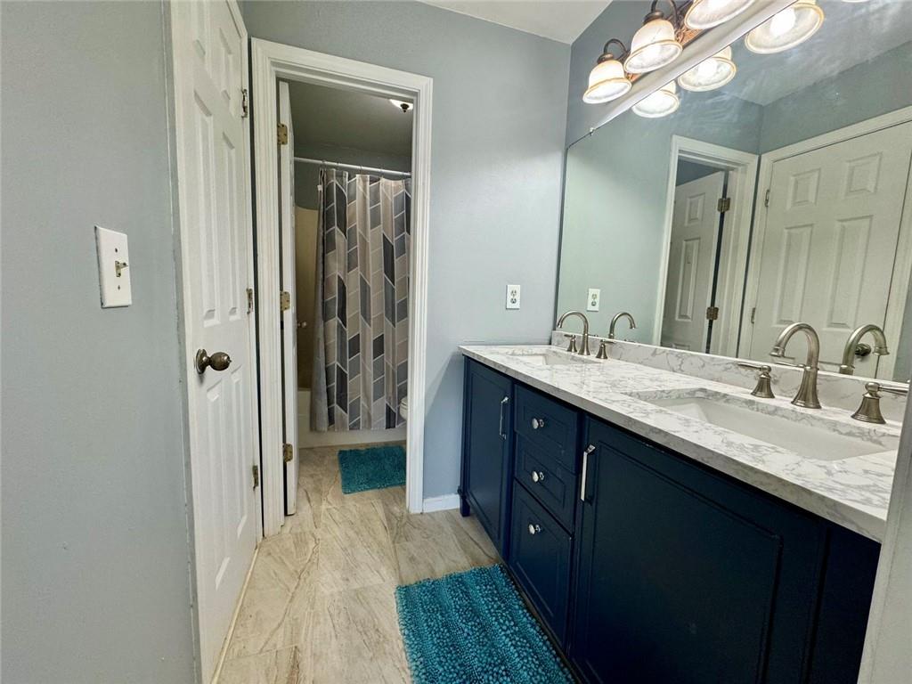 2014 Hubbard Court Villa Rica, GA 30180 - Photo 35 of 41 a en suite bathroom with a sink a mirror and a shower