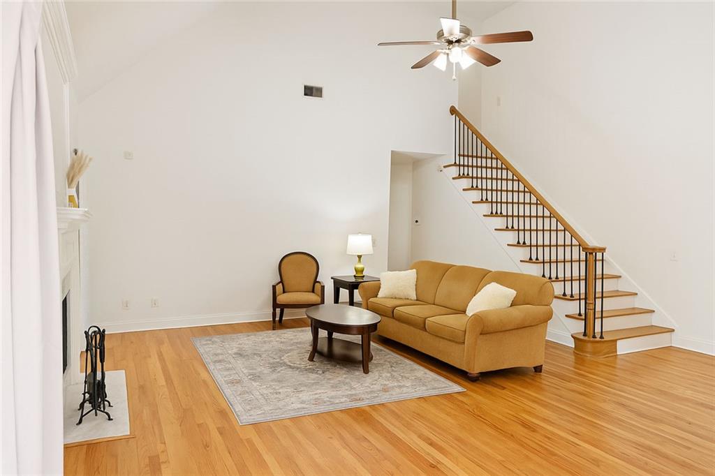 2014 Hubbard Court Villa Rica, GA 30180 - Photo 9 of 41 a living room with couches and a dining table with wooden floor