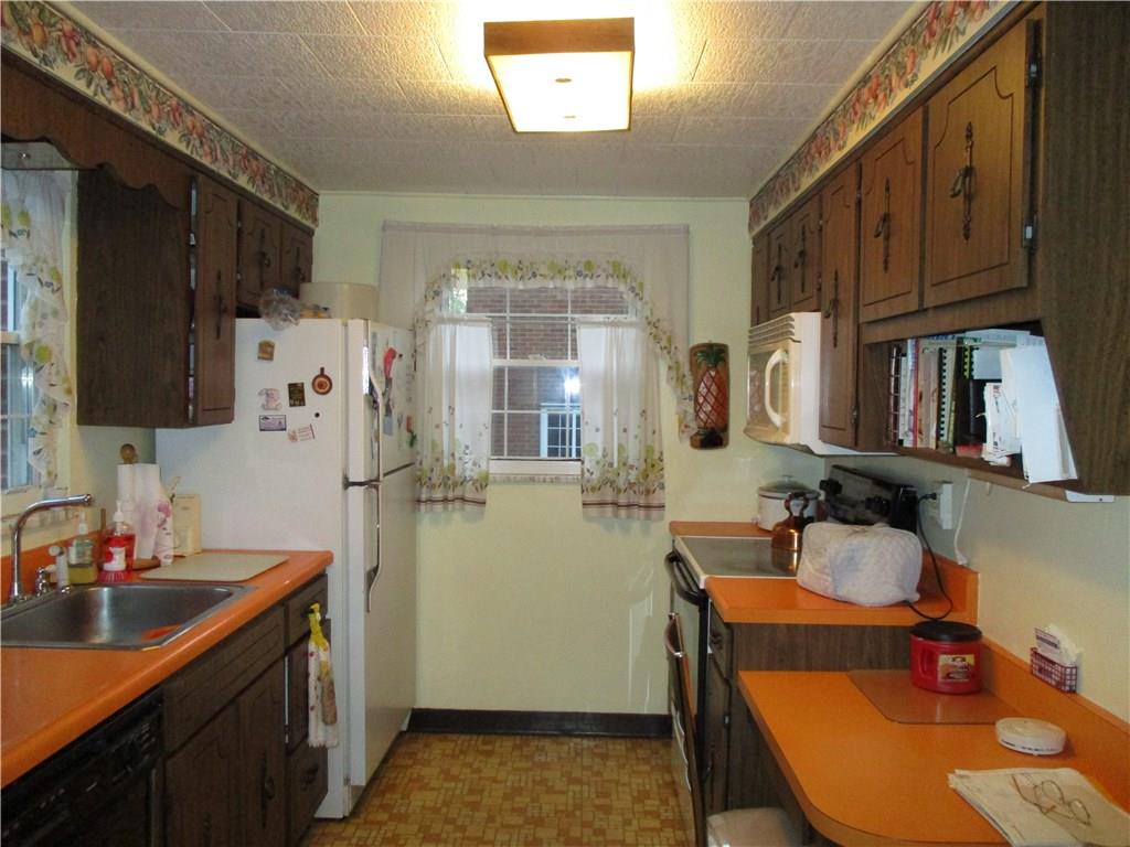 1589 Riverside Drive Verona, PA 15147 - Photo 9 of 16 Galley Kitchen with natural sun light and writing desk