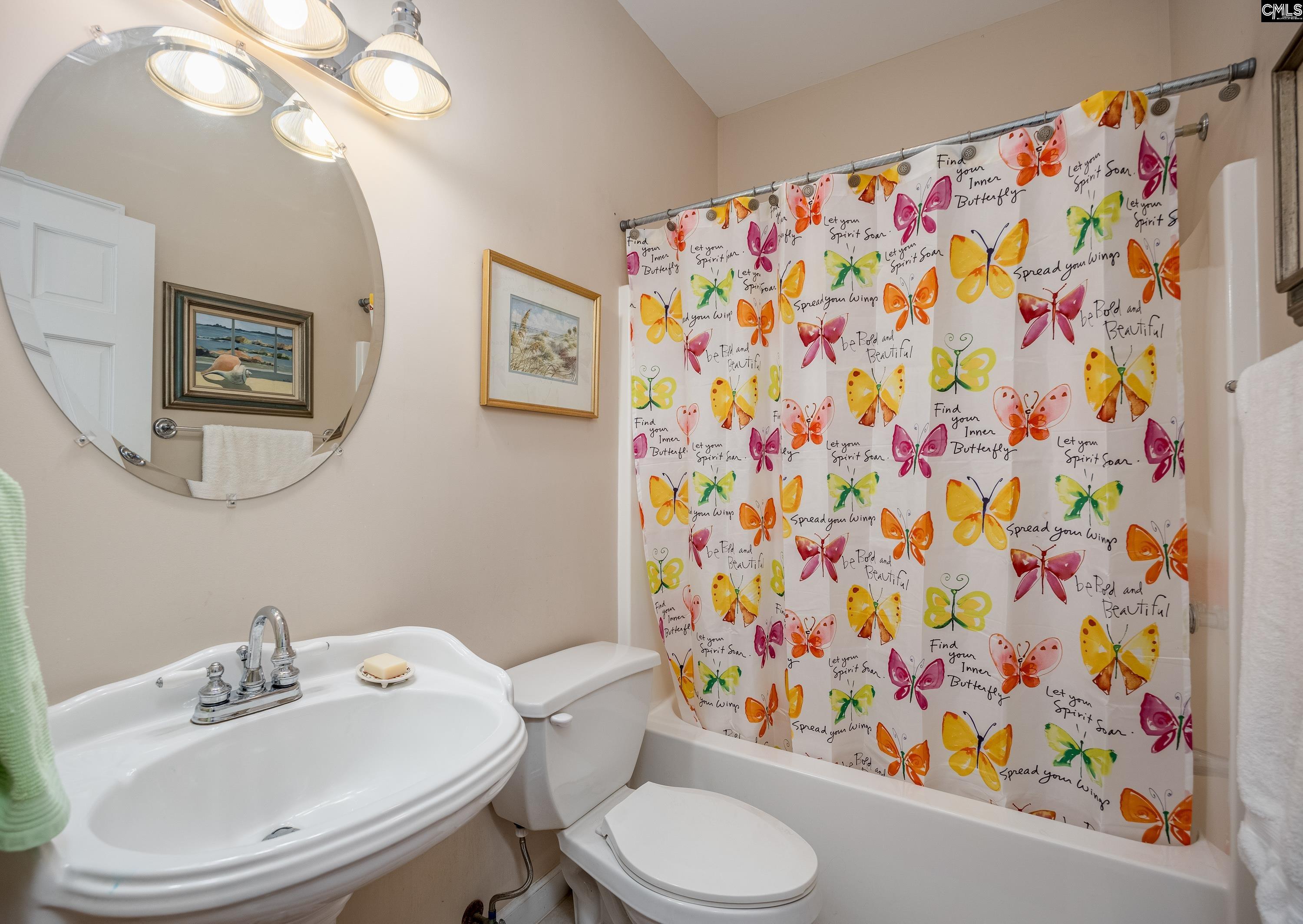 2577 Harbor View Road Camden, SC 29020 - Photo 32 of 42 a white toilet sitting next to a shower curtain