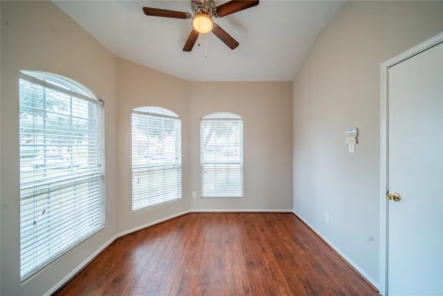 a kitchen with stainless steel appliances granite countertop a stove top oven a sink dishwasher and wooden cabinets with wooden floor