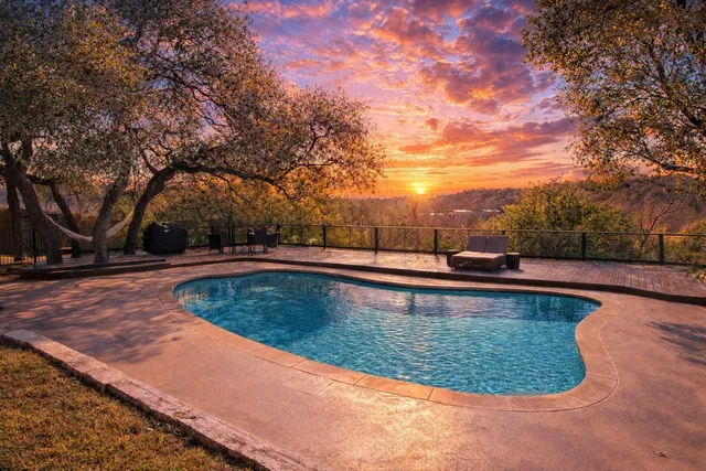 a view of a swimming pool with a yard
