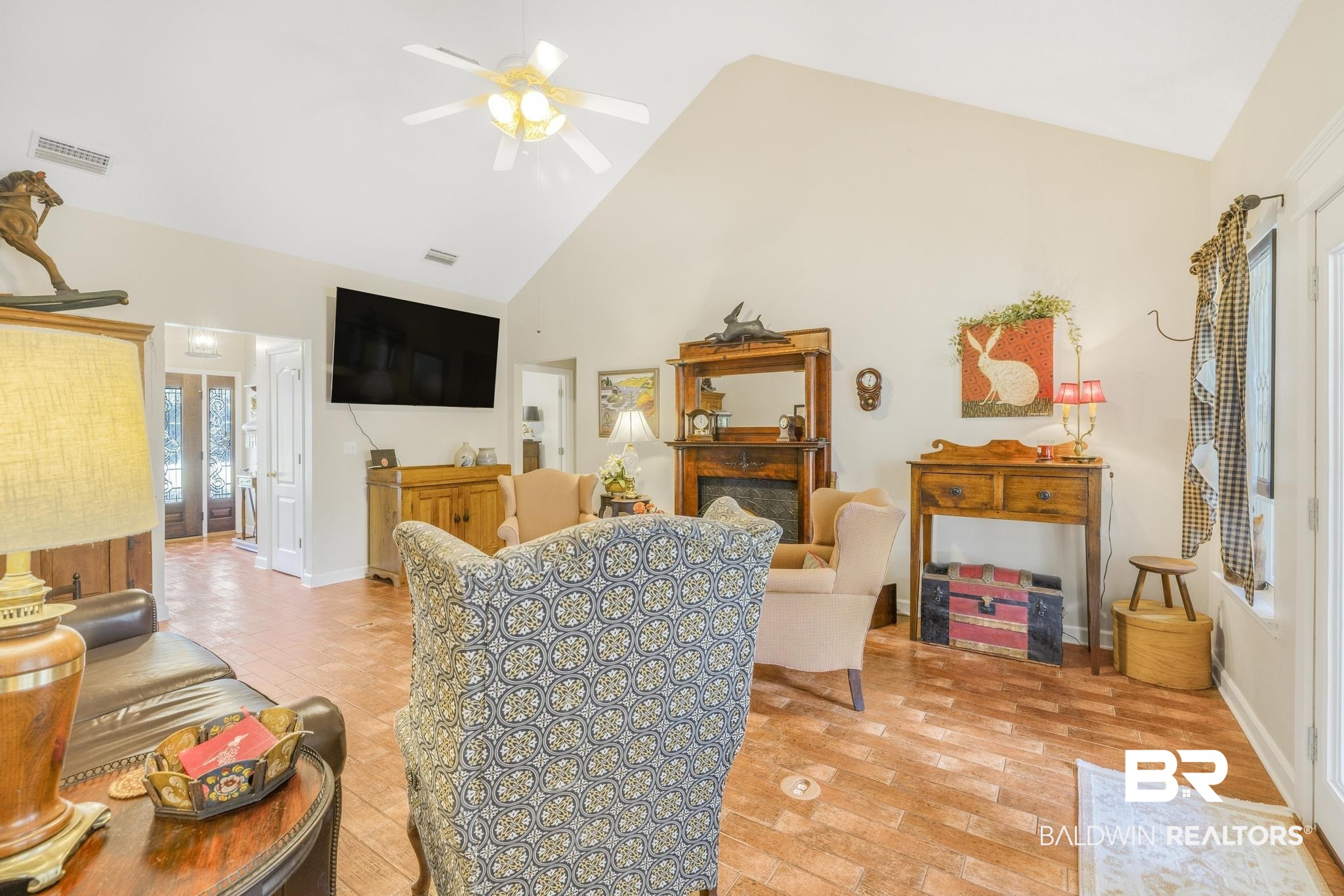 10603 Old Stage Road Stockton, AL 36579 - Photo 12 of 34 Living area with high vaulted ceiling, ceiling fan, a fireplace, and light wood-type flooring