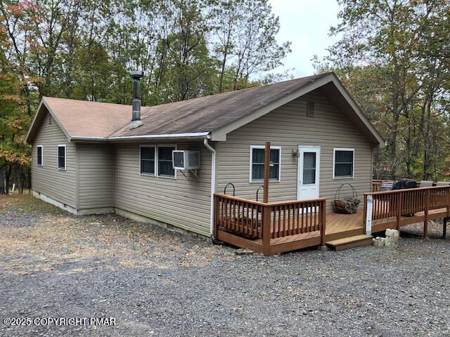 a view of a house with a yard and deck
