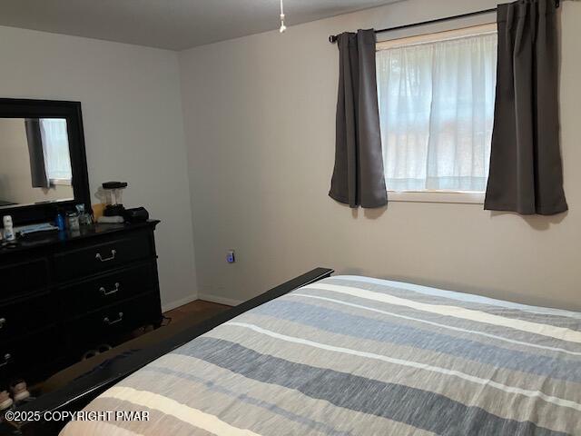 6 Iroquois Road Albrightsville, PA 18210 - Photo 11 of 16 a bedroom with a bed and a flat tv screen next to a window