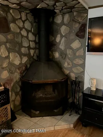 a living room with a table and a fireplace