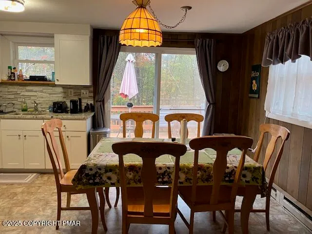 a view of a dining room with furniture and window