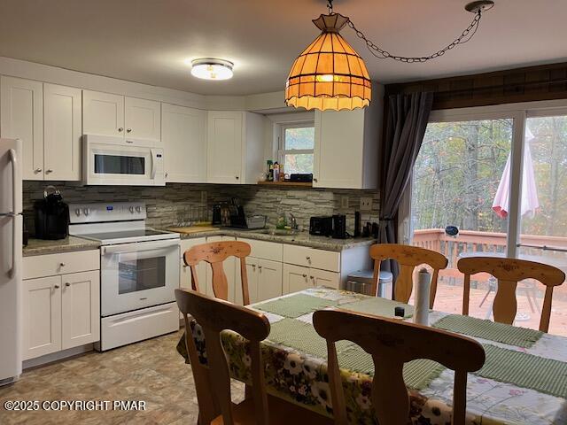 6 Iroquois Road Albrightsville, PA 18210 - Photo 6 of 16 a kitchen with stainless steel appliances granite countertop a stove a sink dishwasher a dining table and chair with wooden floor