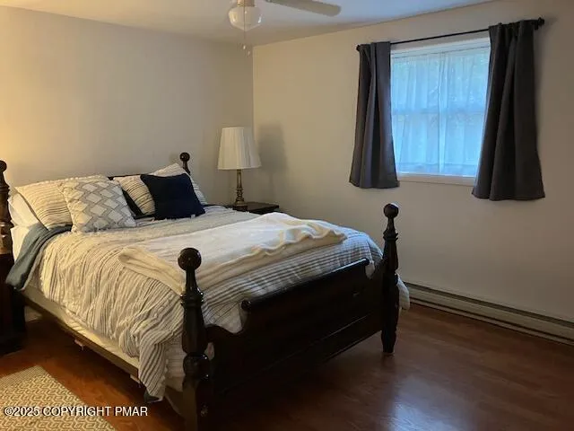 a bedroom with a bed and flat screen tv