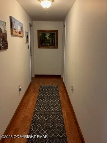 a view of bedroom with wooden floor