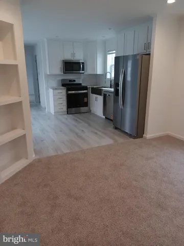 a view of kitchen with refrigerator stove and microwave