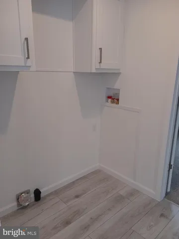 a view of cabinets and wooden floor