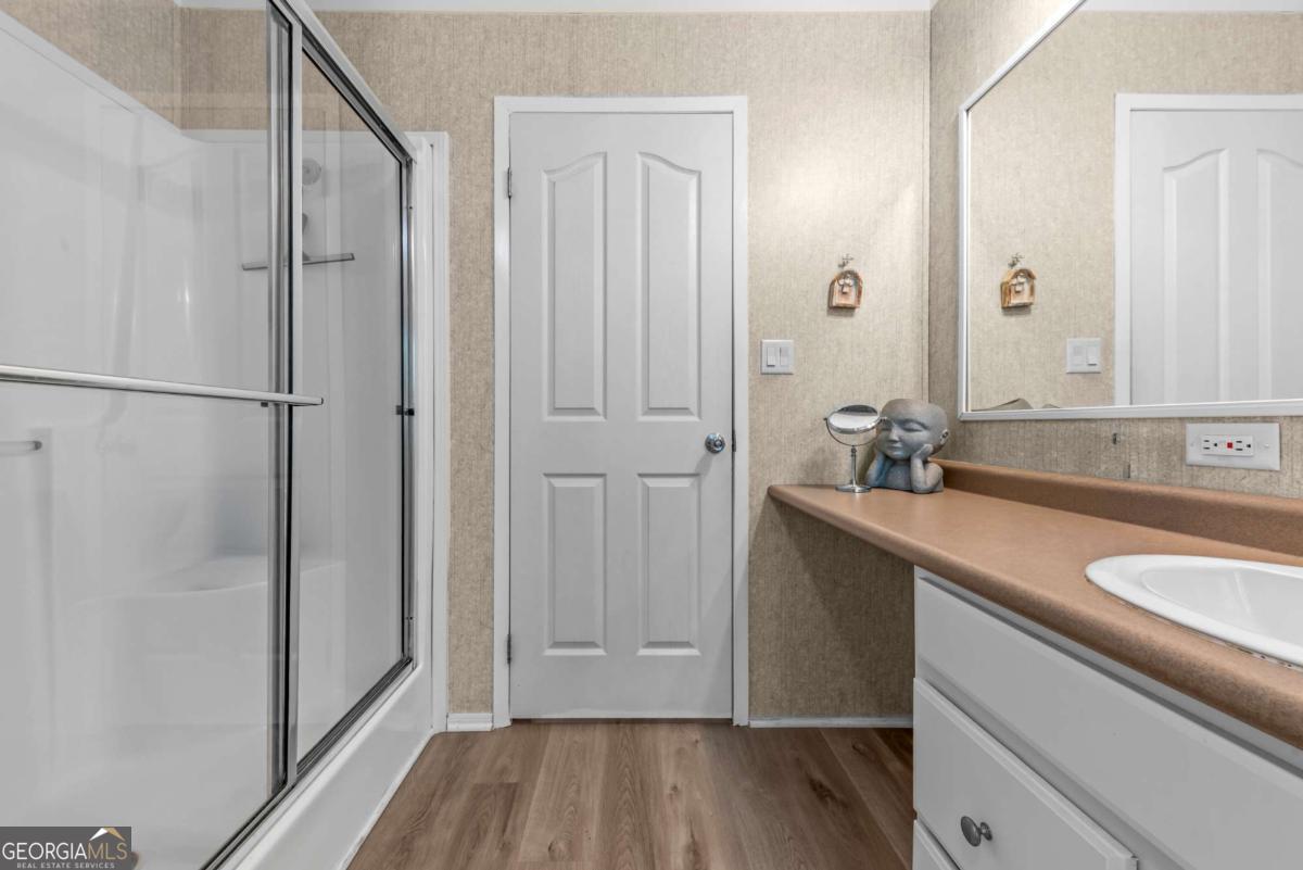 194 Phillips Road Eatonton, GA 31024 - Photo 26 of 57 a bathroom with a sink and mirror