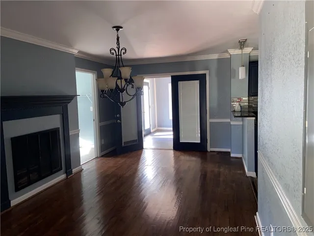 a view of a hallway with wooden floor and a fireplace